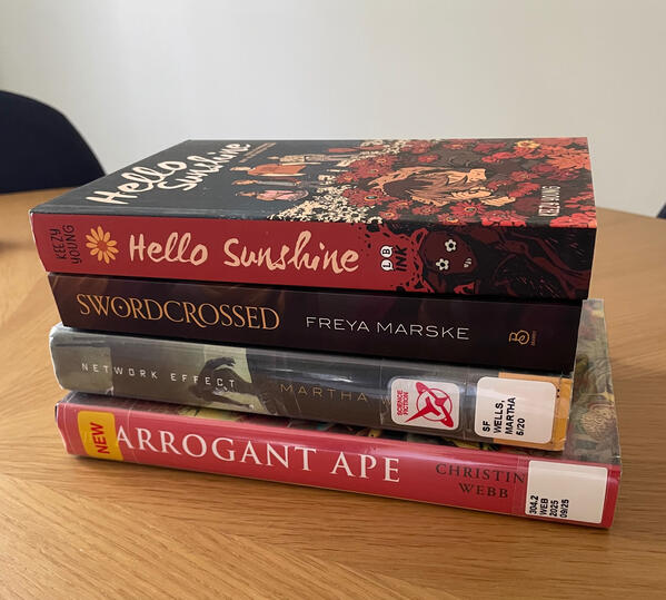 Stack of books Stack of books on a table, some bought and some from library.