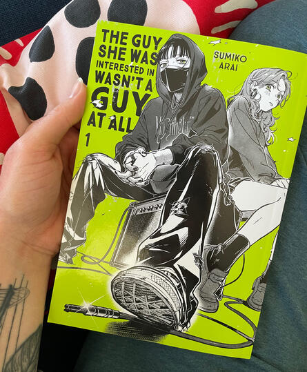 The guy she was interested in Hand holding The Guy She Was Interested In Wasn't A Guy At All graphic novel.
